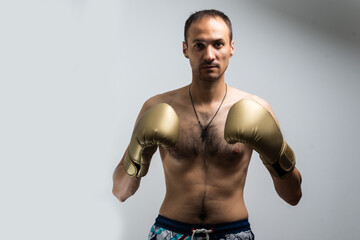 Fototapeta premium The thin man in boxing gloves.