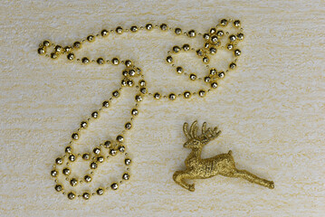New Year. Golden deer and beads