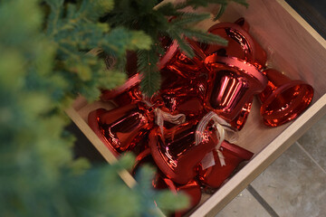 Red bells in a wooden box under the tree
