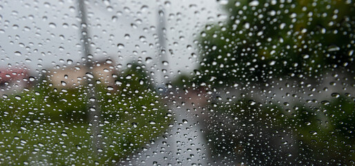 Driving in rain. Selective focus.Road view through car window with rain drops driving in rain. Traffic view from car windscreen in rain.