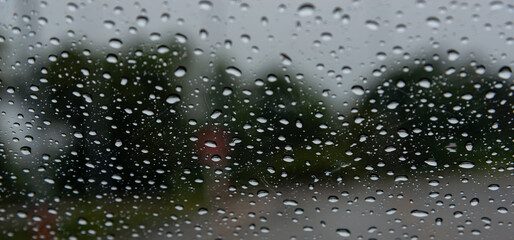 Driving in rain. Selective focus.Road view through car window with rain drops driving in rain. Traffic view from car windscreen in rain.