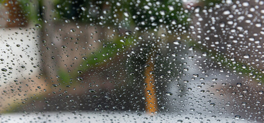 Driving in rain. Selective focus.Road view through car window with rain drops driving in rain. Traffic view from car windscreen in rain.