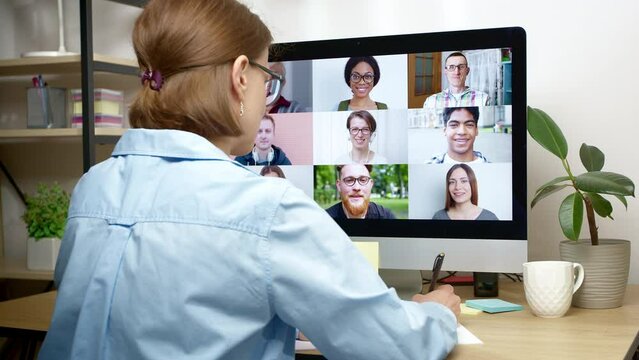 Woman Working On Laptop Holding Online Group Video Conference, Remote Webinar. Team Of Colleagues Talking On Video Call, Brainstorming. Business People Conduct Negotiations Virtually.