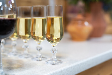 Many glasses of different wine in a row on bar counter