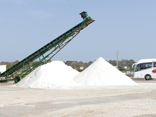 Conveyor belt and mountains of salt in the salt fields of Es Trenc, Mallorca, Balearic Islands, Spain