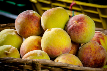 peaches in a basket. sweet fruits for sale in the market. peach for sale. market place in Latin America.    