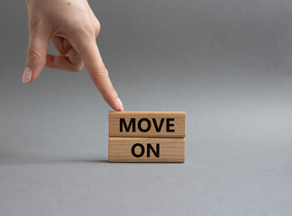 Move on symbol. Wooden blocks with words Move on. Beautiful grey background. Businessman hand. Business and Move on concept. Copy space.