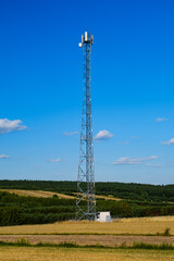 field of wheat and forest with telecommunication station
