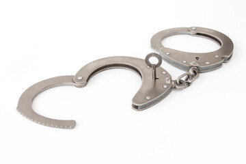 the inserted key opens the handcuffs, on a white isolated background