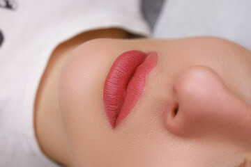close-up of the lips of models on which permanent makeup was done in watercolor technique