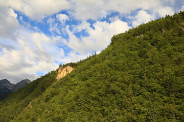 Fototapeta na wymiar Lower valley below the steep mountain 