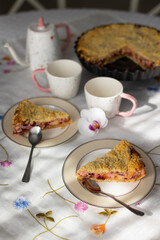 Two pieces of homemade  plum pie with streusel on laid table for meal