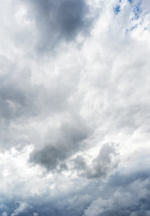 Gray dramatic clouds in the sky, vertical format