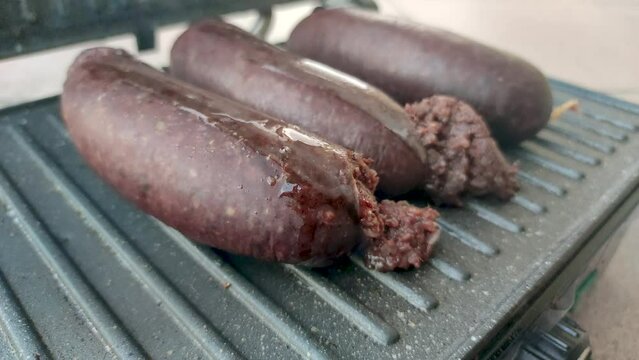 Kaszanka on electric grill. Kaszanka is traditional blood sausage.
