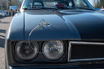 Fototapeta na wymiar Detail of an old sports car, gray Ford Capri with two black stripes