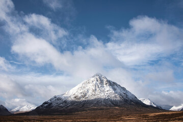 Beautiful iconic landscape Winter image of Stob Dearg Buachaille Etive Mor mountain in Scottish Highlands againstd vibrant blue sky © veneratio