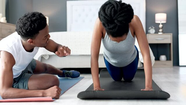 Push ups, motivation and personal trainer couple in bedroom or home doing workout training or exercise together for fitness, wellness or health goal, Love, support and help of black people exercising