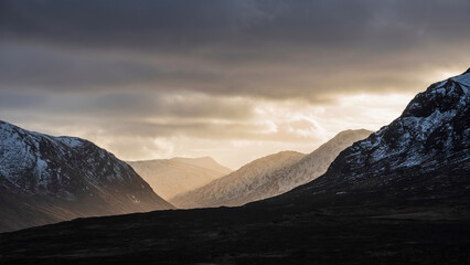 Majestic dramatic Winter sunset sunbeams over landscape of Lost Valley in Etive Mor in Scottish Highlands © veneratio