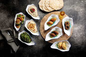 Assorted mix mezza with falafel, pita bread, salad, hummusm, served in a dish side of food set