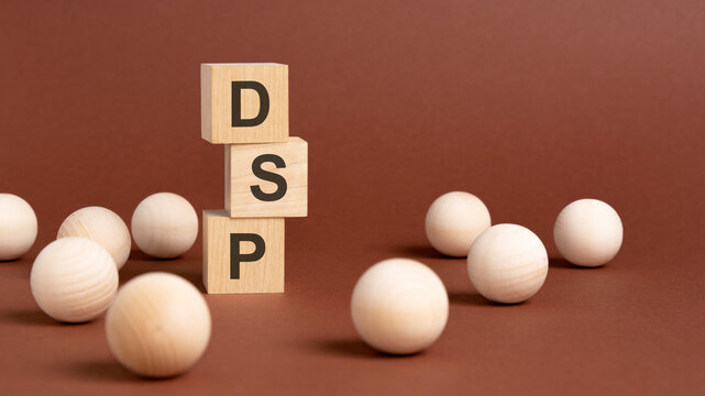 wooden cubes block with text dsp, brown background
