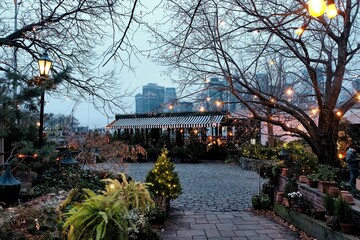 Beautiful view of outdoor cafes near Brooklyn bridge with cityscape in the back