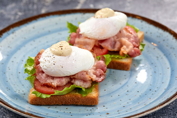 toasts with poached egg and bacon