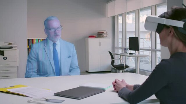 Businesswoman and Businessman Wearing Virtual Reality Glasses Talk using Augmented Reality Metaverse. 