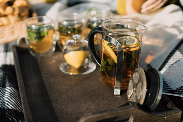 Tea with lemon on a tray with a blanket in nature. Autumn Picnic