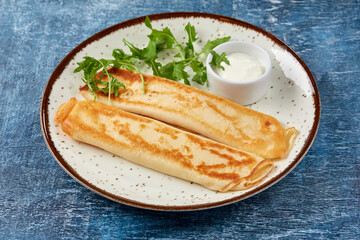 tasty breakfast with pancakes and herbs