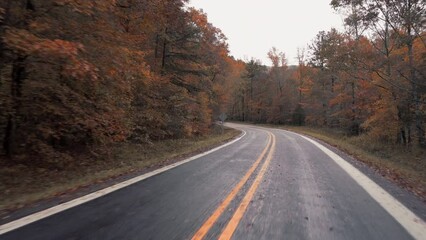 Fall drive though Autumn cored forest in rural Arkansa in the Ozark Mountains 