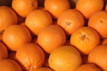 close-up of oranges in the market. background of delicious citrus fruits, healthy food concept