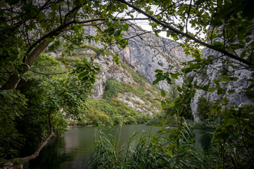 Beautiful rocky cliffs and mountain peaks, covered with dense forest near the town of Omis, Croatia in the Cetina river canyon