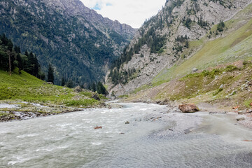 Naklejka na ściany i meble Beautiful Kashmir Landscape. Lush green meadows, river and mountains of Kashmir