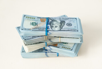 New design US Dollar bills bundles stack on beige background including clipping path