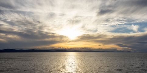 Cloudy Cloudscape during sunny summer Day on the West Coast of Pacific Ocean. British Columbia, Canada. Sunset Sky