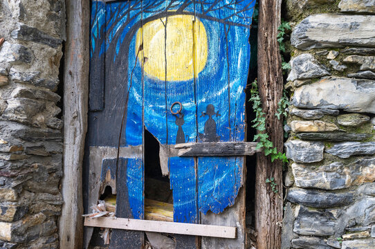 Typical hand-made painted old wooden door, in the village of Triora (Liguria Region, Imperia Province, Northern Italy). Located near the french borders, is famous for its legends of medieval witches.