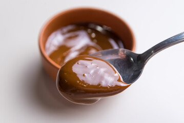 close up of spoon in dulce de leche