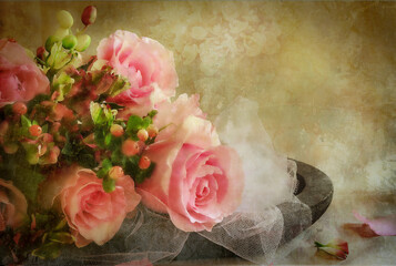Pink wedding bridal roses with tulle against warm textured background.