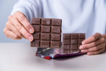woman's hands offering a chocolate.