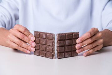 woman's hands breaking a chocolate