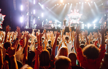Fototapeta na wymiar Сrowd with raised hands at music festival. Youth, party, vacation concept.
