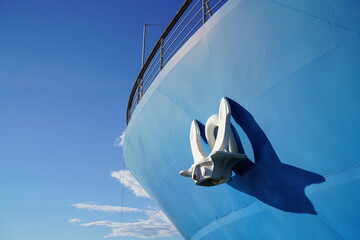 Ship's Bow and Anchor against a blue Sky - Monochrome  in Blue with Spots of White
