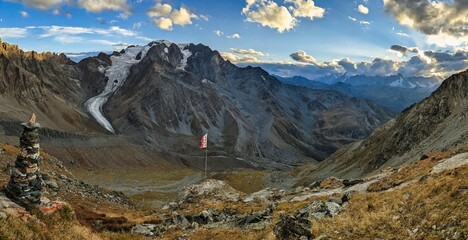 Great Panorama view of Mont Vélan from the cabane de valsorey with a Valais flag in the wind. Mountain tour in the Swiss mountains. High quality photo