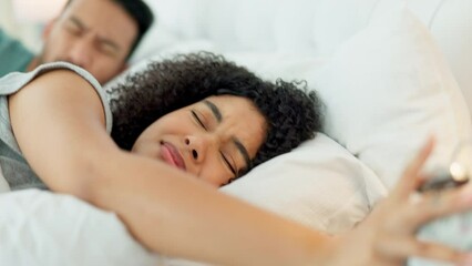 A couple in bed, an alarm and weekend morning to relax, cuddle and sleep late. Love, rest and a tired man and woman sleeping in on a public holiday. Time to dream, a clock and comfort in the bedroom.