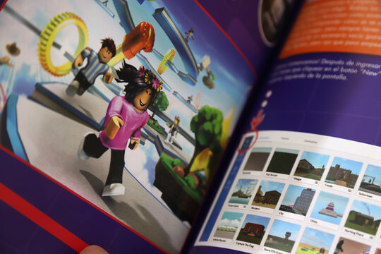 Book about the video game The best Roblox games. Images of the characters of the games. Magazine.  Roblox video game. Online multiplayer game. Inside pages.