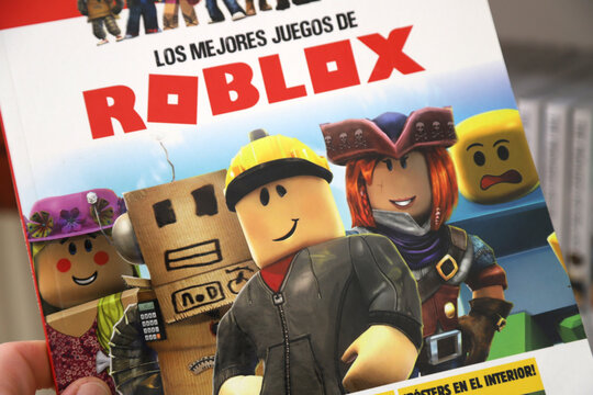 Book about the video game The best Roblox games. Images of the characters of the games. Magazine cover. Roblox video game. Online multiplayer game.