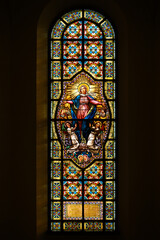 Stained-glass window depicting the Assumption of the Virgin Mary. Blumental church in Bratislava, Slovakia. 2021/07/20.