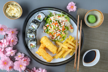 Japanese dish of rolls and fish in batter on a plate