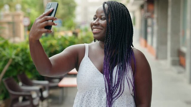 African american woman smiling confident making selfie by the smartphone at coffee shop terrace