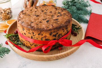 Homemade Christmas fruit cake decorated with red ribbon
